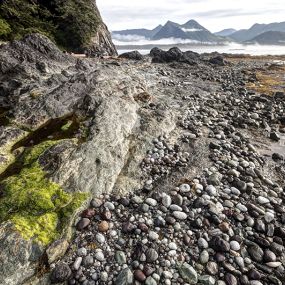 photo of rugged west coast shoreline, ocean, and mountains in Kyuquot, BC